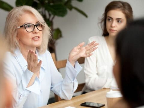 Woman in business meeting making a point