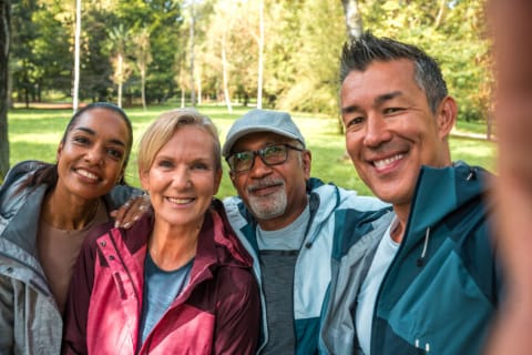 Group of diverse older parents smiling for selfie